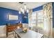 Light and airy dining room with blue accent wall, modern lighting, and floral curtains at 6133 Buttonwood Dr, Noblesville, IN 46062