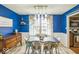 Dining room with bright blue walls and windows overlooking yard at 6133 Buttonwood Dr, Noblesville, IN 46062