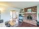 Well-lit living room showcasing a cozy brick fireplace and hardwood floors, creating a welcoming atmosphere at 6133 Buttonwood Dr, Noblesville, IN 46062