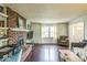 Cozy living room featuring a brick fireplace, hardwood floors, and ample natural light at 6133 Buttonwood Dr, Noblesville, IN 46062