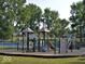 Community playground surrounded by mature trees with slides and climbing equipment at 6133 Buttonwood Dr, Noblesville, IN 46062