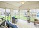 Bright sunroom with tile floor, ceiling fan, and sliding glass doors to backyard at 6133 Buttonwood Dr, Noblesville, IN 46062