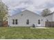 A well-maintained backyard features a patio and an exterior door to the home at 6212 Monteo Dr, Indianapolis, IN 46217
