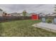 Large backyard featuring a patio with outdoor seating and a bright red shed at 6212 Monteo Dr, Indianapolis, IN 46217