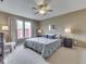 Spacious bedroom with plush carpeting, ceiling fan and large windows with natural light at 6212 Monteo Dr, Indianapolis, IN 46217