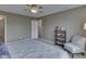 Spacious bedroom with ceiling fan, chair and shelving at 6212 Monteo Dr, Indianapolis, IN 46217