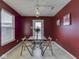 Eat-in kitchen featuring bright lighting, a tile tabletop and white appliances in red colored walls at 6212 Monteo Dr, Indianapolis, IN 46217
