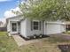 Charming home exterior with gray siding, a two car garage and well-kept landscaping at 6212 Monteo Dr, Indianapolis, IN 46217