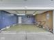 Spacious two car garage with overhead lighting and workspace with a door to interior at 6212 Monteo Dr, Indianapolis, IN 46217