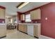 Bright kitchen with oak cabinets and white appliances at 6212 Monteo Dr, Indianapolis, IN 46217