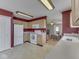 Bright eat-in kitchen with white appliances, light cabinetry and access to the living room at 6212 Monteo Dr, Indianapolis, IN 46217