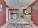 Eat-in kitchen featuring bright lighting, a tile tabletop and white appliances in red colored walls at 6212 Monteo Dr, Indianapolis, IN 46217