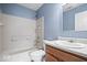 A full bathroom with tub and shower, white fixtures, and modern sink and vanity at 6259 Bishops Pond Ln, Indianapolis, IN 46268