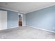 A light blue bedroom with plush carpeting, a white door and bathroom entrance visible at 6259 Bishops Pond Ln, Indianapolis, IN 46268