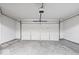 A clean garage with white walls, concrete floor and an automatic door at 6259 Bishops Pond Ln, Indianapolis, IN 46268