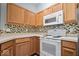 Bright kitchen with appliances, featuring tile backsplash at 6259 Bishops Pond Ln, Indianapolis, IN 46268