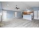Spacious living area featuring a ceiling fan and light gray wood-look floors at 6259 Bishops Pond Ln, Indianapolis, IN 46268