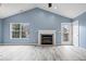 Inviting living room features a fireplace, large window, and a door to a deck at 6259 Bishops Pond Ln, Indianapolis, IN 46268