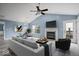 Bright, open-concept living room with modern decor, vaulted ceiling, fireplace, ceiling fan, and hardwood floors at 6259 Bishops Pond Ln, Indianapolis, IN 46268