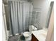 Bathroom features a shower/tub, gray shower curtain and an open rack at 6479 Enclave Blvd, Greenwood, IN 46143