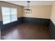 Dining Room featuring wainscoting and a modern light fixture at 6479 Enclave Blvd, Greenwood, IN 46143