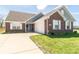 Charming brick home featuring a well-manicured lawn and an inviting front entrance at 6479 Enclave Blvd, Greenwood, IN 46143