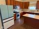 Kitchen featuring an island, stainless steel appliances, and wood cabinets at 6479 Enclave Blvd, Greenwood, IN 46143