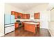 Open kitchen with island, stainless appliances, and wood cabinetry at 6479 Enclave Blvd, Greenwood, IN 46143