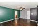 Spacious bedroom featuring en-suite bathroom, stylish color scheme, and dark wood flooring at 6479 Enclave Blvd, Greenwood, IN 46143
