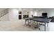 Finished basement with ping pong table, bar area, and comfortable seating at 6590 W Deerfield Dr, Zionsville, IN 46077
