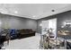 Recreational room with dark walls featuring a full drum set, sofa and grand piano at 6590 W Deerfield Dr, Zionsville, IN 46077