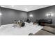 Basement bonus room with drum set, piano, and comfortable seating area at 6590 W Deerfield Dr, Zionsville, IN 46077
