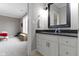 This bathroom has a vanity with granite countertop, a framed mirror, and a view to the bedroom at 6590 W Deerfield Dr, Zionsville, IN 46077