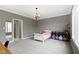 A gray bedroom features carpet, gray walls, white crown molding, and closet at 6590 W Deerfield Dr, Zionsville, IN 46077