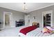 Gray bedroom with red accents and a view to an ensuite bathroom and closet at 6590 W Deerfield Dr, Zionsville, IN 46077