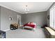 This bedroom has a chandelier, gray walls, carpet, and a large window at 6590 W Deerfield Dr, Zionsville, IN 46077