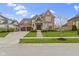Beautiful brick home with stone accents, a two-car garage, and a well-manicured front yard at 6590 W Deerfield Dr, Zionsville, IN 46077