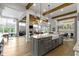Open concept kitchen with large island, farmhouse sink, and view of the living area at 6590 W Deerfield Dr, Zionsville, IN 46077