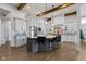 Spacious kitchen with a large island, granite countertops, stainless appliances, and stylish pendant lighting at 6590 W Deerfield Dr, Zionsville, IN 46077