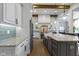 Bright kitchen with stainless steel appliances, granite countertops, and a gray tiled backsplash at 6590 W Deerfield Dr, Zionsville, IN 46077