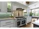 Gourmet kitchen with stainless steel range, custom hood, and decorative corbels at 6590 W Deerfield Dr, Zionsville, IN 46077