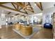 Open concept living space with beamed ceilings, a gray sofa, and gourmet kitchen views at 6590 W Deerfield Dr, Zionsville, IN 46077