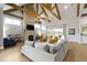 Spacious living room with stone fireplace, beamed ceilings, and sliding glass doors at 6590 W Deerfield Dr, Zionsville, IN 46077