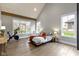 Spacious bedroom featuring a vaulted ceiling, wood floors, a Peloton, and large windows overlooking a well-manicured lawn at 6590 W Deerfield Dr, Zionsville, IN 46077