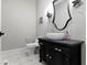Stylish powder room featuring a vessel sink on a black cabinet and an ornate mirror at 6590 W Deerfield Dr, Zionsville, IN 46077