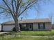 Charming one-story home with attached two-car garage and well-maintained lawn, shaded by a mature tree at 6611 Kellum Dr, Indianapolis, IN 46221