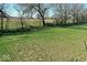 Backyard image shows a large grassy area surrounded by trees at 6917 Wheatley Rd, Whitestown, IN 46075