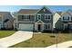 Charming two-story home with gray siding, attached two-car garage, and well-manicured front lawn at 6917 Wheatley Rd, Whitestown, IN 46075