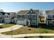 Charming two-story home with gray siding, attached two-car garage, and well-manicured front lawn at 6917 Wheatley Rd, Whitestown, IN 46075