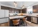 Modern kitchen featuring dark cabinets, stainless steel appliances, granite countertops, and a center island at 6917 Wheatley Rd, Whitestown, IN 46075